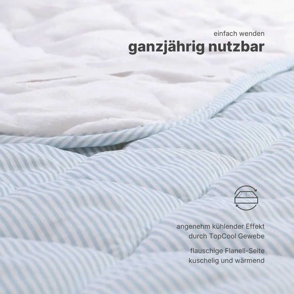 Zweiseitige TopCool Matratzenauflage mit kühlender Sommerseite und wärmender Flanellseite, ganzjährig nutzbar durch einfaches Wenden