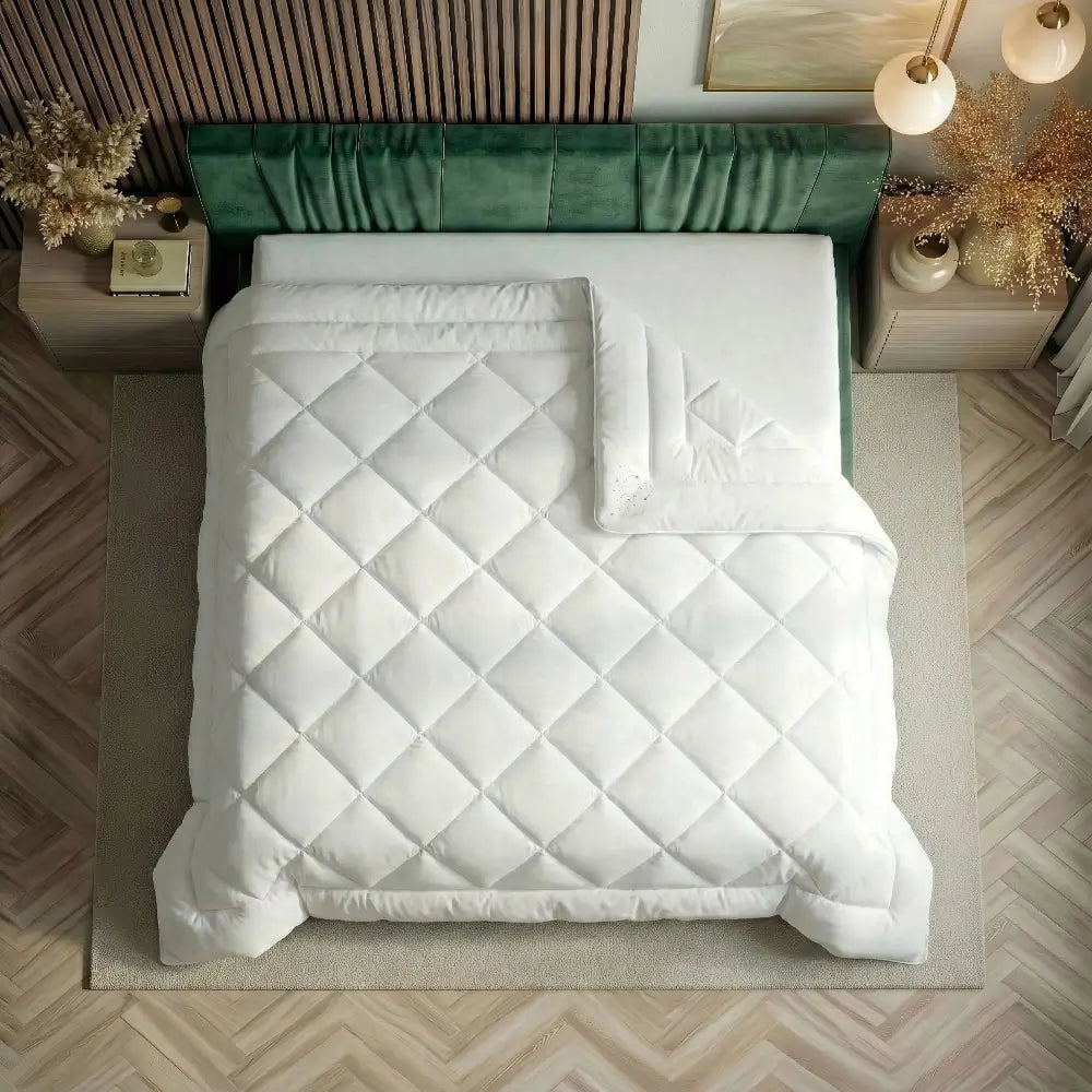 Vegane Bettdecke von oben auf einem grünen Bett